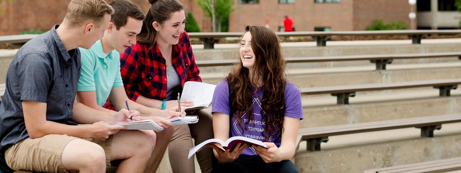 students walking on campus carrying backpacks or on phones